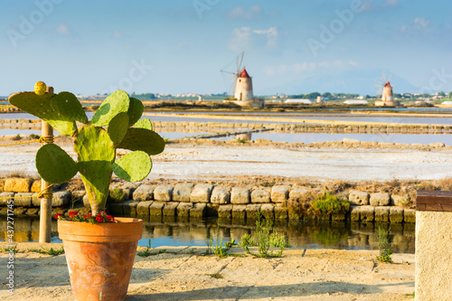 Sunset at Windmills in the salt evoporation pond in Marsala, photo