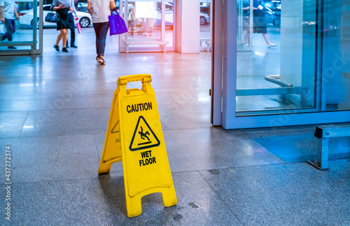 Konstfotografi "Caution wet floor" sign in mall