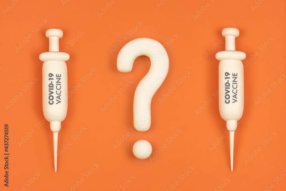 Vaccine hesitancy concept, syringes with vaccine and question mark