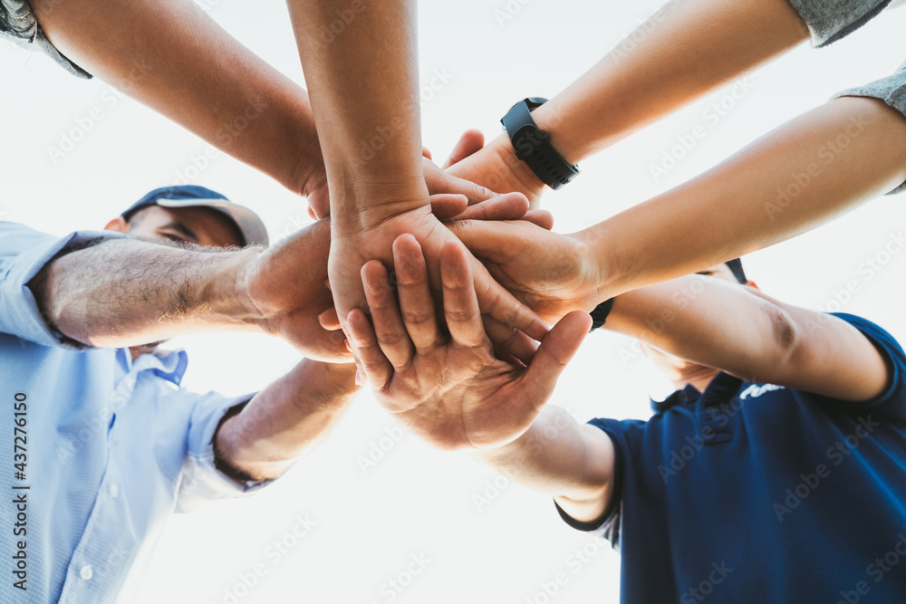People putting their hands together. Friends with stack of hands showing unity and teamwork. Friendship happiness leisure partnership team concept.