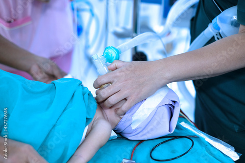 Nurse holding oxygen mask for a child patient. General anesthesia before cardiac surgery