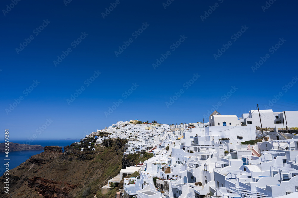 Scenic cityscape of Imerovigli. city on the hill. White architecture. Santorini island, Greece. Luxury tourism.