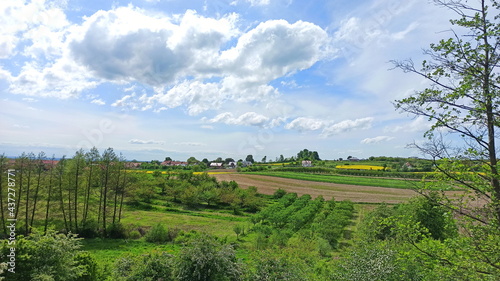 Green landscape with blue sky and village in Lower Silesia area. Beautiful spring in Poland.