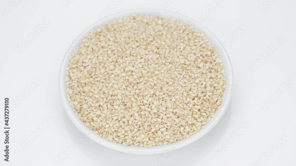 sesame seeds in plate, white background. 4K UHD video sesame seeds in plate, white background. 4K UHD video