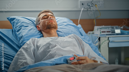 Hospital Ward: Portrait of Handsome Young Man Wearing Nasal Cannula Sleeping in Bed, Fully Recovering after Sickness. Male Patient Dreaming About His Long and Happy Future Life