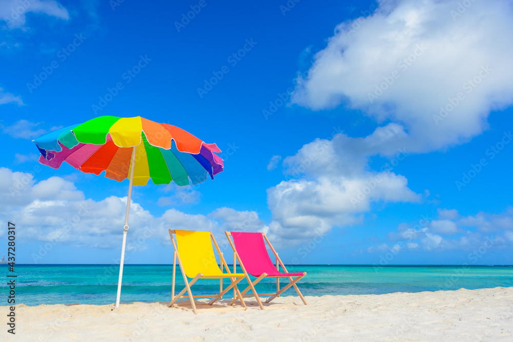 Beach chairs with umbrella on the shoreline, beautiful beach