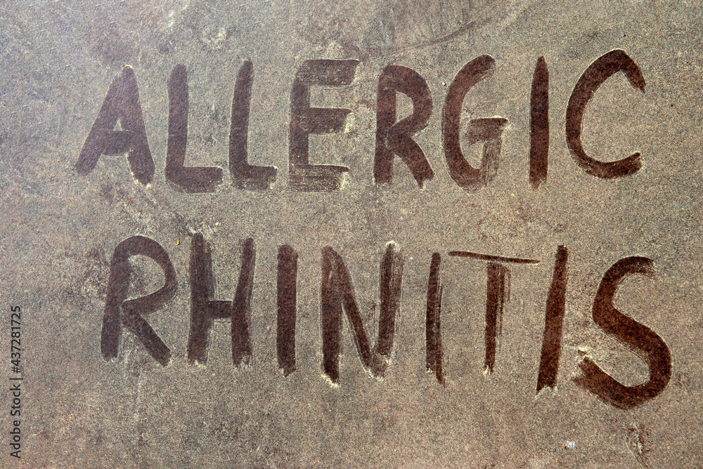 Allergic rhinitis text over yellow pollen grains on the background. Allergic rhinitis text over yellow pollen grains on the background.