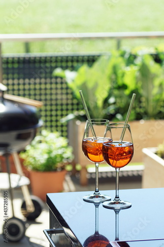 Fototapet two summer apperitive drinks on a table on a balcony garden