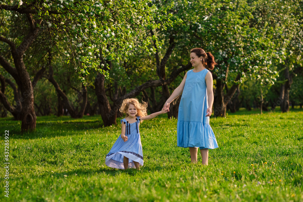 nature scene with family outdoor lifestyle. Mother and little daughter playing together in a park. Happy family concept. Happiness and harmony in family life. nature scene with family outdoor lifestyle. Mother and little daughter playing together in a park. Happy family concept. Happiness and harmony in family life.