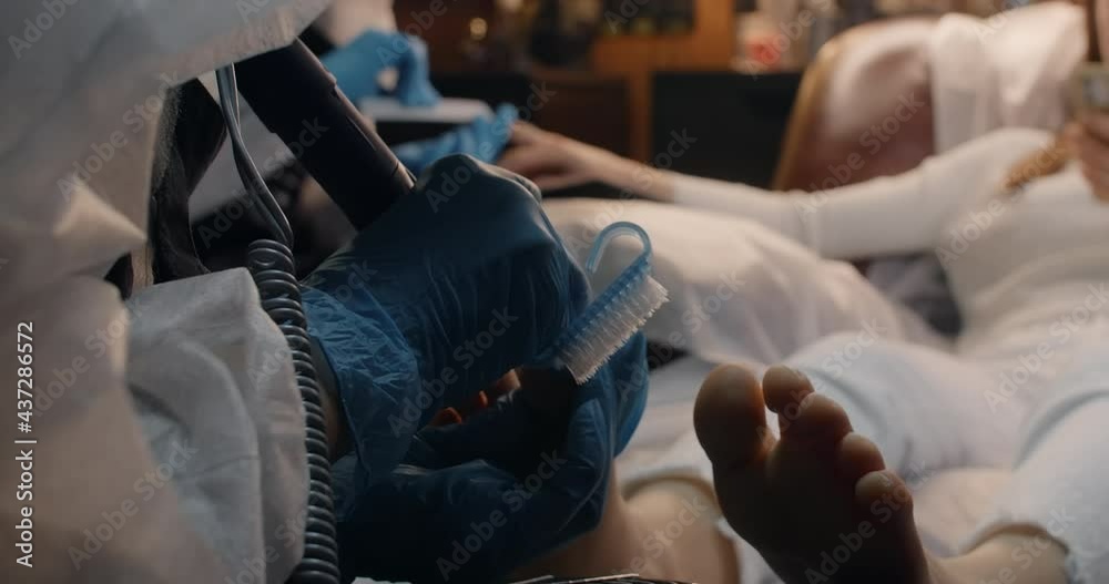 Woman gets VIP all inclusive care with manicure pedicure and hair cutting in the same time by six hands at the beauty salon, three masters works with one client, 4k Prores HQ
