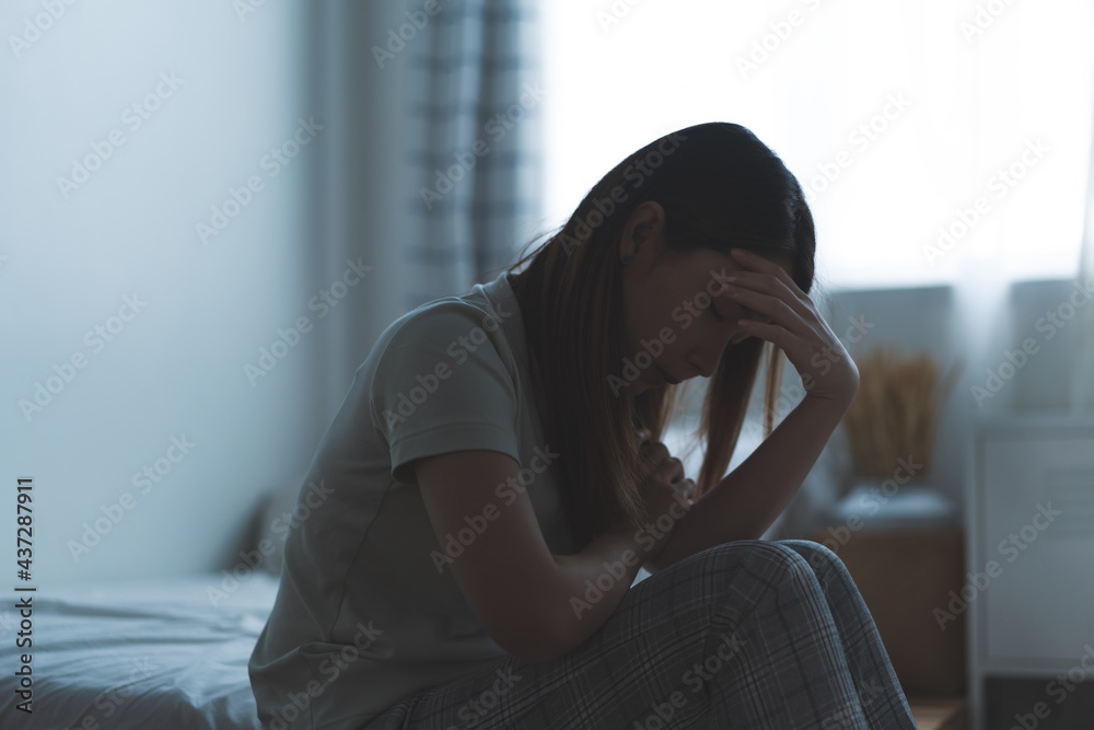 Depressed woman sitting on the bed had bad emotional feel lonely at home. concept of sadness and relationship breakdown Depressed woman sitting on the bed had bad emotional feel lonely at home. concept of sadness and relationship breakdown