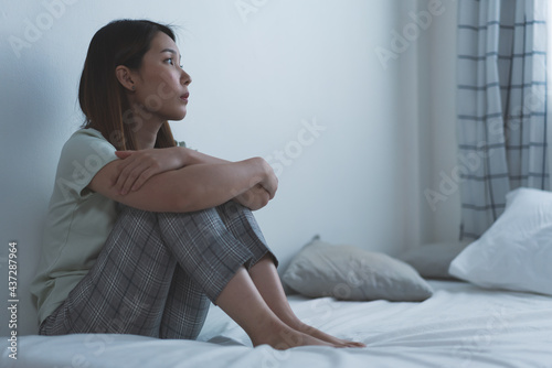 Depressed woman sitting on the bed had bad emotional feel lonely at home. concept of sadness and relationship breakdown