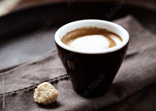 Coffee with milk on dark background. Soft focus. Close up. 