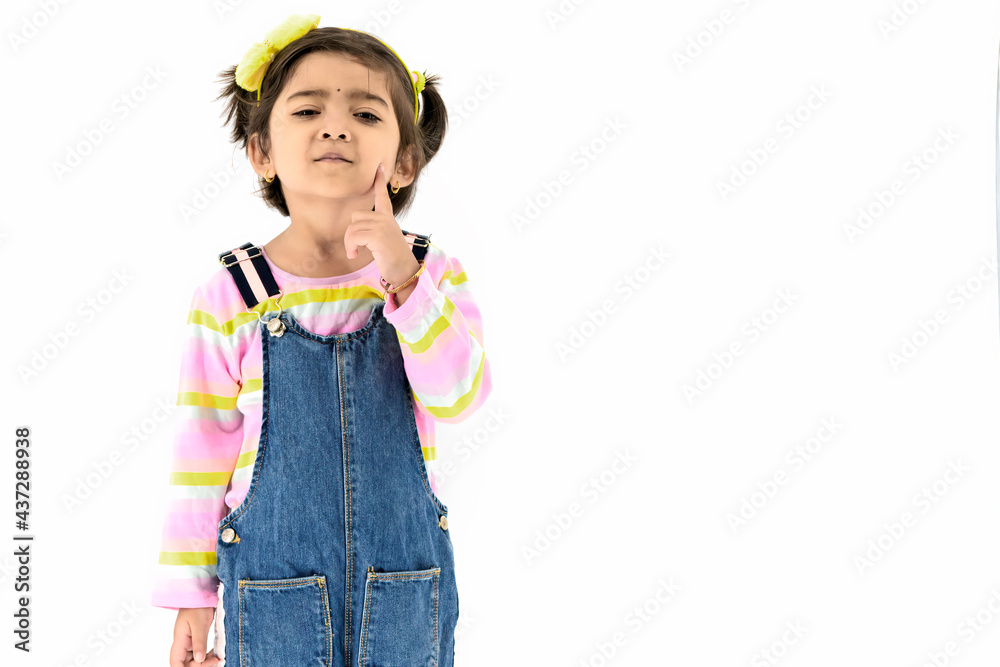 Portrait little Asian girl standing and thinking something and smile with happiness select focus shallow depth of field with copy space and white background. Portrait little Asian girl standing and thinking something and smile with happiness select focus shallow depth of field with copy space and white background.