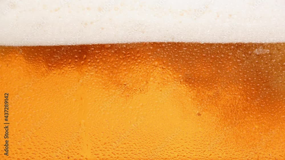 Close up background of beer with bubbles in glass Close up background of beer with bubbles in glass