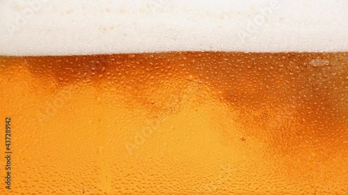 Close up background of beer with bubbles in glass