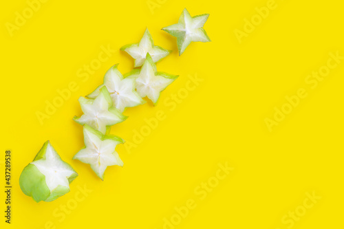 Star fruit slices on yellow surface