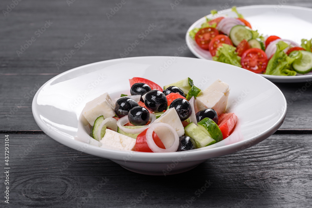 Fresh delicious Greek salad with tomato, cucumber, onions and olives with olive oil