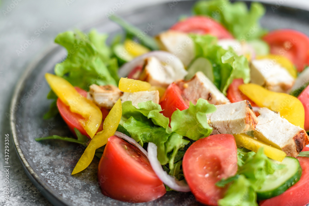 Fresh delicious salad with chicken, tomato, cucumber, onions and greens with olive oil Fresh delicious salad with chicken, tomato, cucumber, onions and greens with olive oil