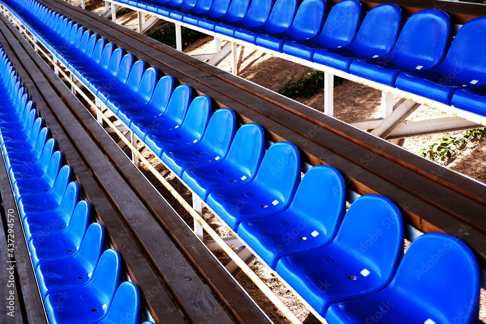 Fototapeta premium blue plastic seats in the sports arena. chairs on the football field. arena