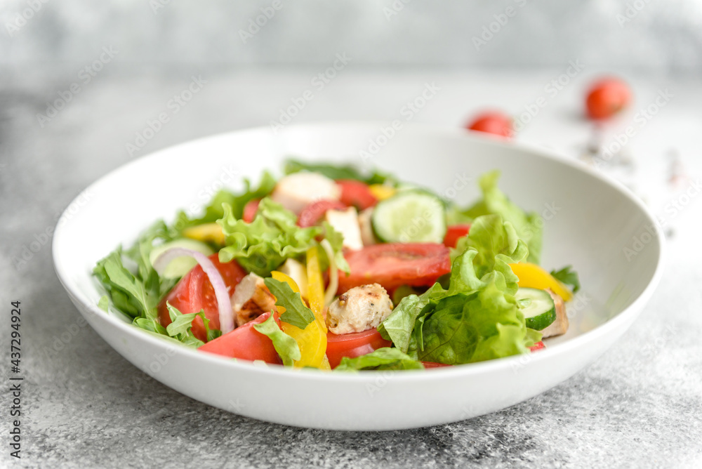 Fresh delicious salad with chicken, tomato, cucumber, onions and greens with olive oil Fresh delicious salad with chicken, tomato, cucumber, onions and greens with olive oil