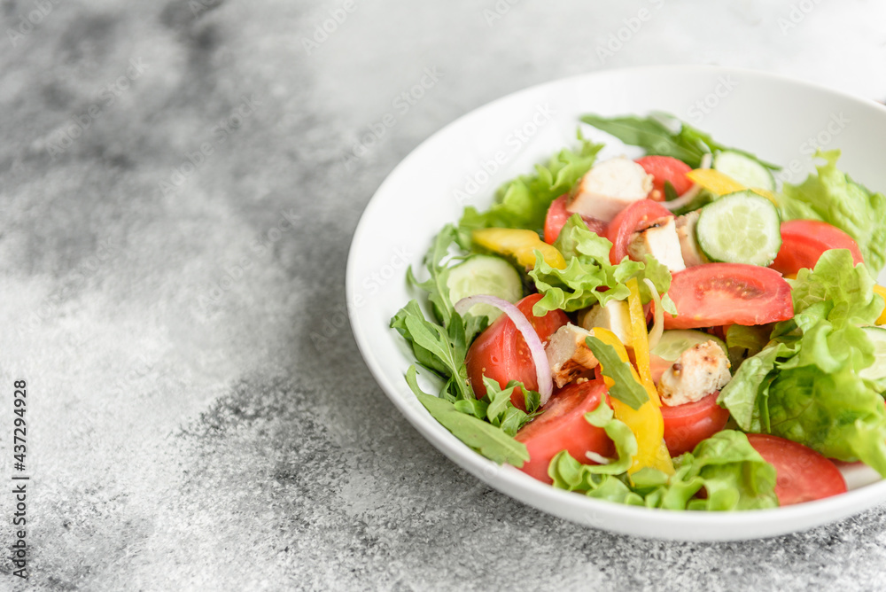 Fresh delicious salad with chicken, tomato, cucumber, onions and greens with olive oil Fresh delicious salad with chicken, tomato, cucumber, onions and greens with olive oil
