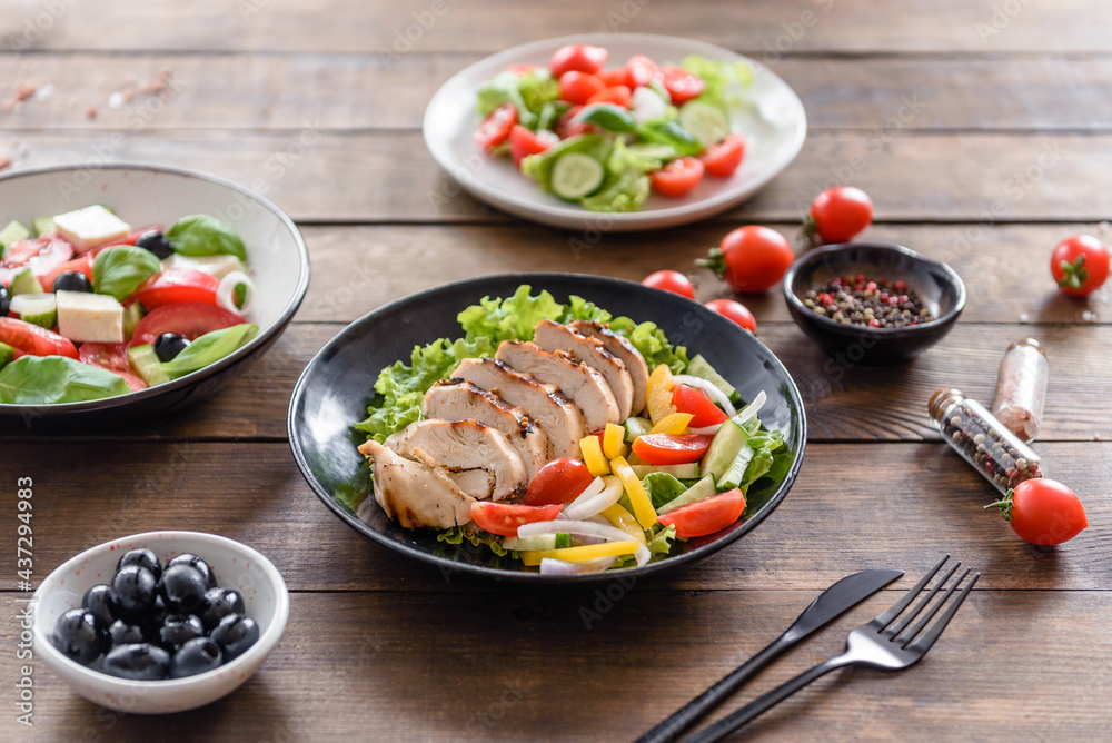 Fresh delicious salad with chicken, tomato, cucumber, onions and greens with olive oil Fresh delicious salad with chicken, tomato, cucumber, onions and greens with olive oil