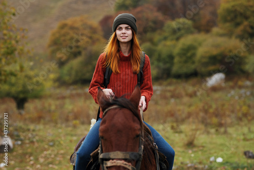 cheerful woman tourist riding a horse nature fun adventure © SHOTPRIME STUDIO