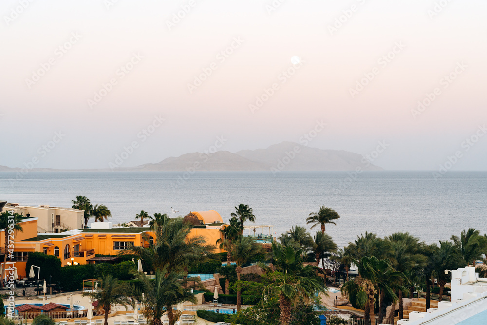Panoramic view of sunny beach in tropical resort in Red Sea. Island in the middle of the sea