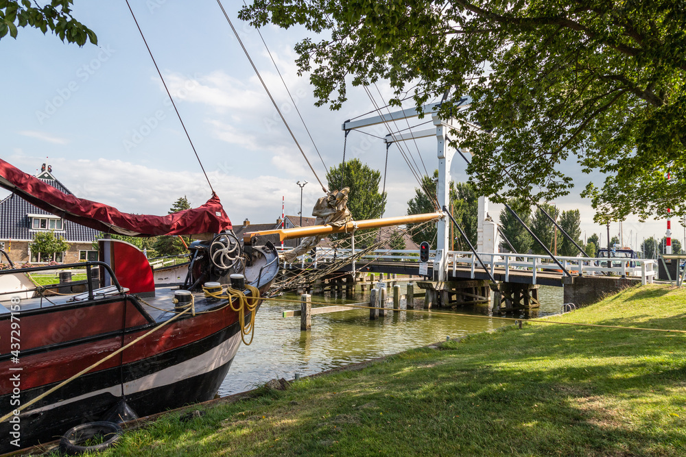 A white drawbridge called Koebrug in the center of the Dutch picturesque fishing village of Stavoren. A white drawbridge called Koebrug in the center of the Dutch picturesque fishing village of Stavoren.
