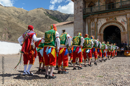 Photography Peruvian folkloric dance, with colorful costumes in front of The Church of San Pedro Apostle of Andahuaylillas, Quispicanchi, near Cusco, Peru on October 7, 2014