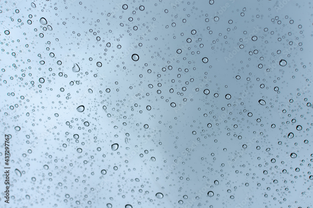 Raindrops on a transparent surface. Transparent drops of water on glass.