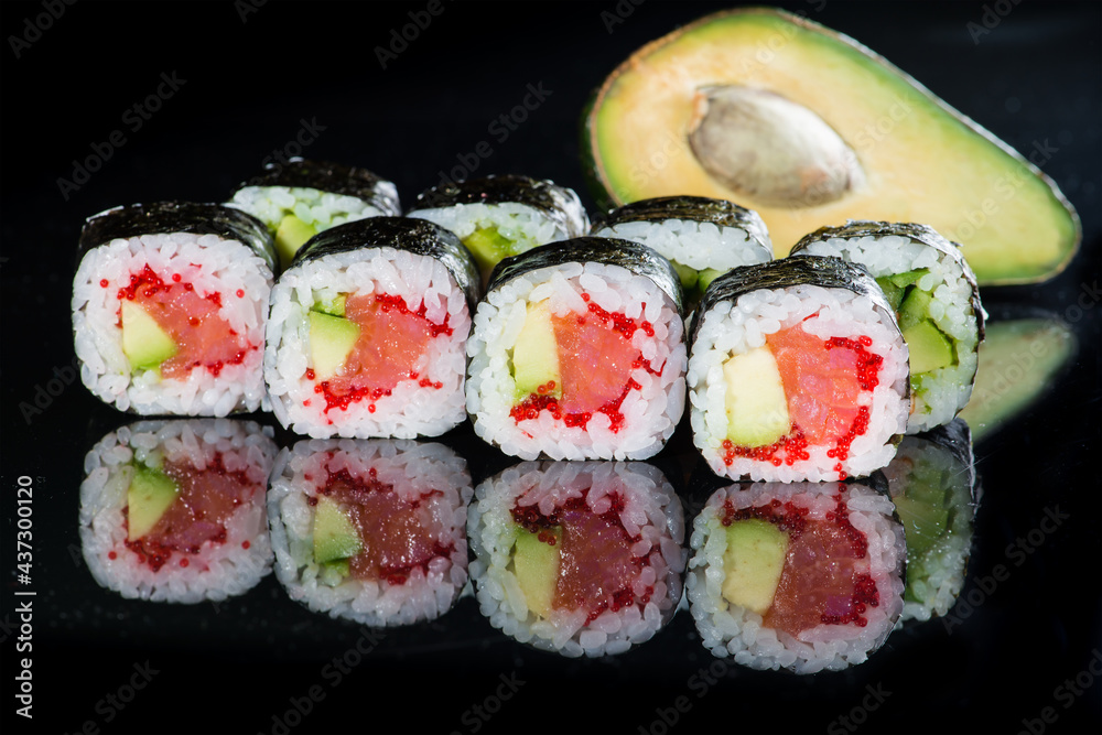 Tasty fresh Sake Avocado Maki sushi with rice, avocado, tobiko a Tasty fresh Sake Avocado Maki sushi with rice, avocado, tobiko a