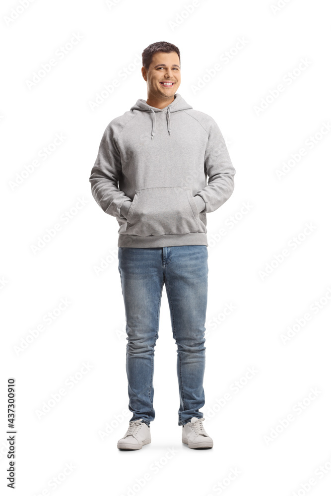 Full length portrait of a young man in a gray hoodie and jeans Full length portrait of a young man in a gray hoodie and jeans
