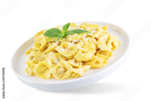 Fresh prepared Tortellini pasta with basil on a white isolated background