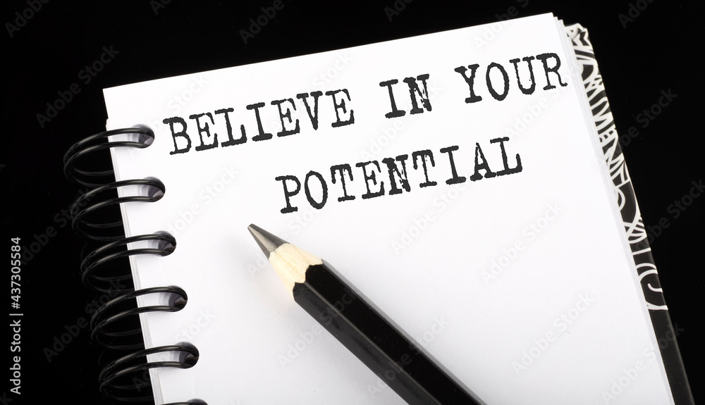 Believe In Your Potential written text in small notebook on a black background Believe In Your Potential written text in small notebook on a black background
