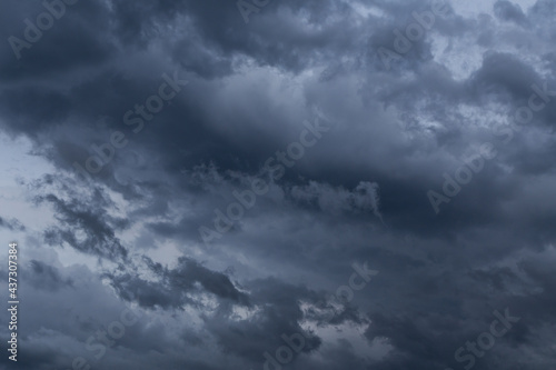 Epic dramatic storm sky with dark grey black cumulus rainy clouds in the wind, background, texture, thunderstorm