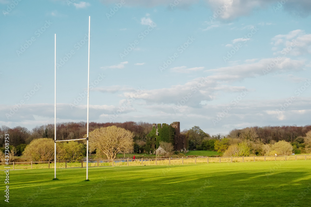 Tall goal posts for Irish national sports, camogie, hurling, Gaelic football, soccer and rugby. Warm sunny day. Blue cloudy sky. Menlo castle in the background. Galway city, Ireland
