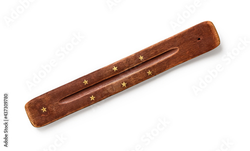 Joss stick stand isolated on white background. Indian incense stick holder of sandalwood close-up. Natural wood incense burner decorated with seven golden stars for aromatherapy and meditation.