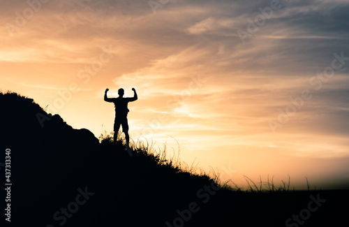Victory on top a mountain. Hiker celebrating victory after climbing mountain. 