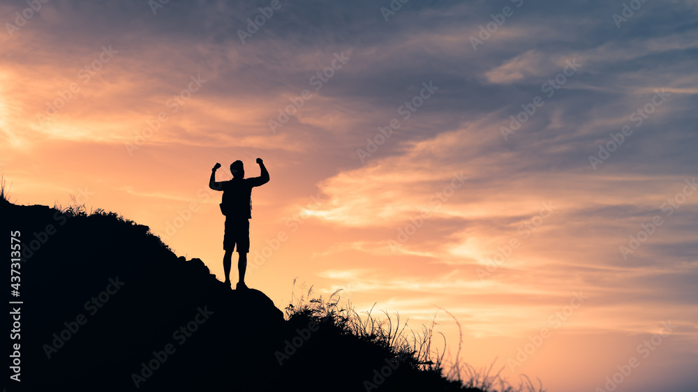 Male hiker celebrating on top of mountain. Victory, strength  and adventure concept. 