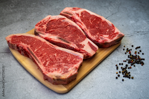 Raw pieces of fresh beef on a cutting board.