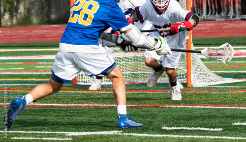 Lacrosse player shooting the ball during a game photo