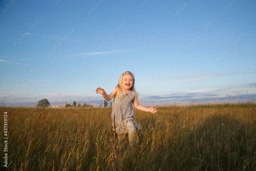 Candid portrait of happy toddler girl on a meadow Candid portrait of happy toddler girl on a meadow