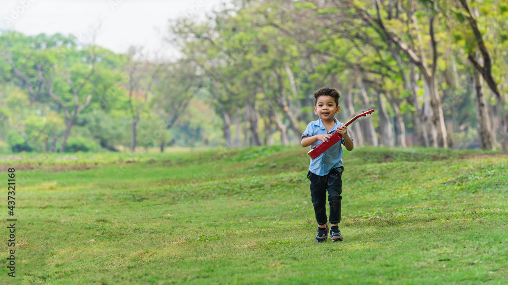 Fototapeta premium mixed race caucasian and asian boy having fun playing in park