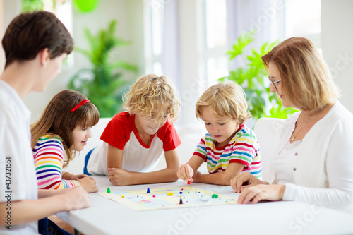 Family playing board game. Kids play.