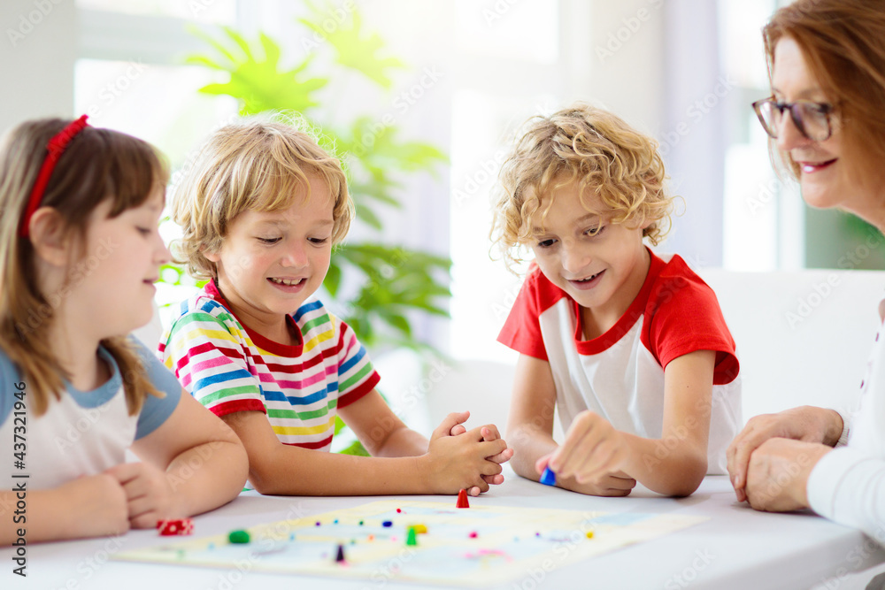 Family playing board game. Kids play.