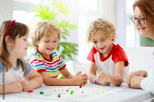 Family playing board game. Kids play.