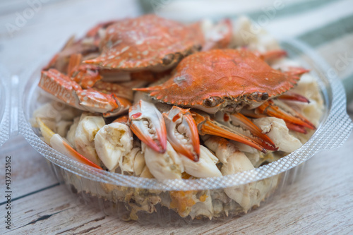 Steamed horse crab claws in circle box on wooden board background
