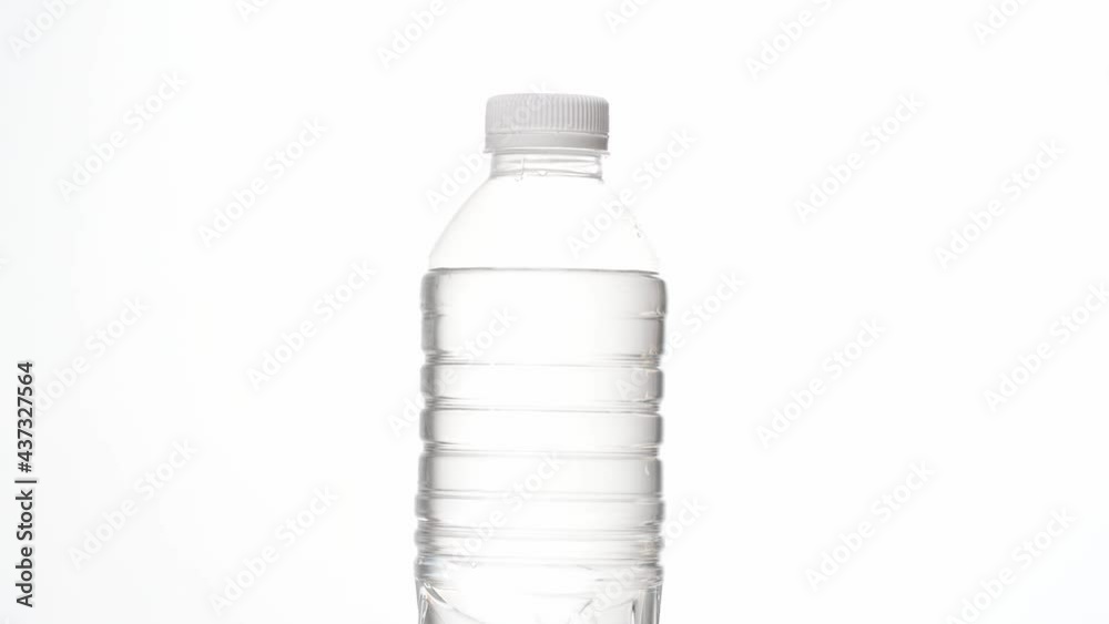 Close up of clean and clear plastic drinking water bottle isolated on white background in 4K footage. Close up of clean and clear plastic drinking water bottle isolated on white background in 4K footage.